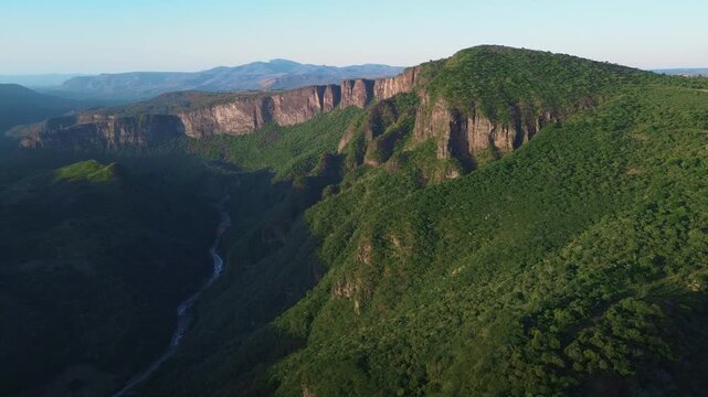 Majestic Santiago River and Mountain Canyon at Sunset Featuring a Cinematic Aerial Drone Push In View of Lush Green Forests in Guadalajara Mexico