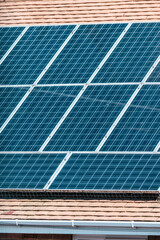 Fototapeta premium Residential houses with rooftop solar panels, renewable energy for sustainable homes
