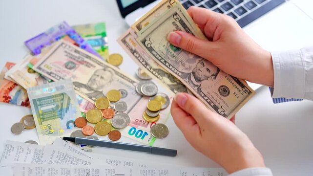 Woman calculating monthly home expenses, taxes and bank account balance.
