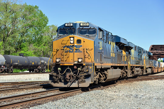CSX Transportation locomotives lead a stack train through a double diamond crossing in south suburban Chicago.