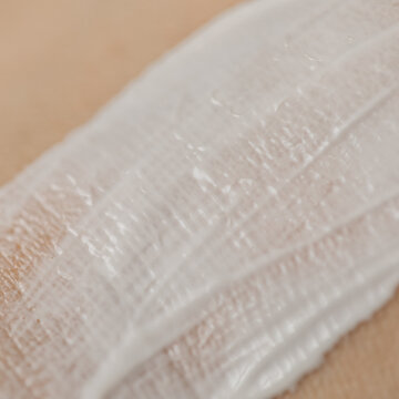 closeup White thick cream or lotion on the Caucasian skin texture 