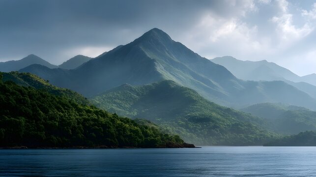 Layered mountain ranges are enveloped in thick atmospheric mist and heavy clouds creating a dramatic and serene landscape view