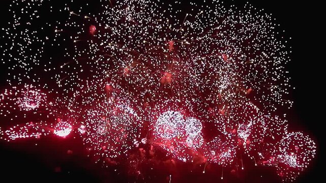 Experience vibrant red and white fireworks lighting up night sky at special occasions, evoking joy, excitement, and festivity, making them ideal for joyful gatherings and celebratory atmospheres