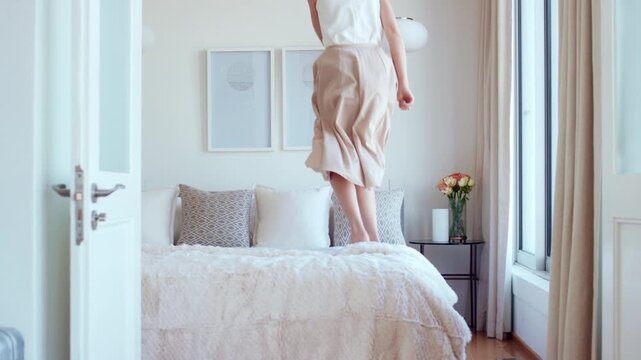 Getaway, fun and woman on bed with jump, travel optimism and happiness on summer holiday. Smile, suitcase or person in hotel room with good time, vacation enjoyment or playful energy in bedroom.