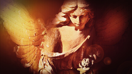 Fototapeta premium Gothic cemetery angel with illuminated wings and emotional atmosphere