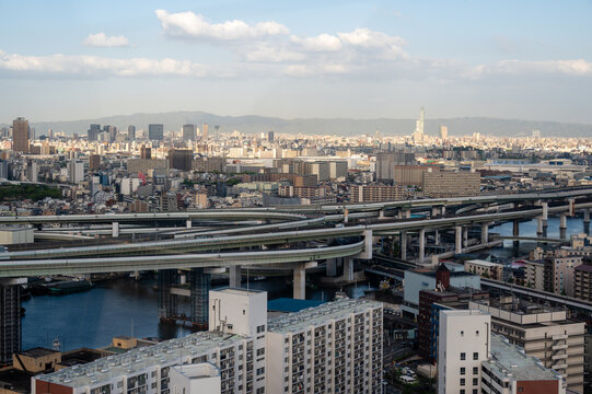 Complex multi-level highway interchange flyover and city skyline in Osaka, Japan
