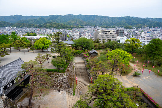 Aerial view of Kochi Castle stone walls and park with festival lanterns, Japan