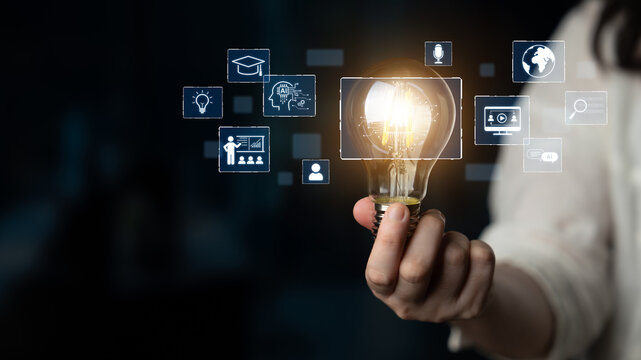 Innovative Concept of Open Mind and Creativity with Person Holding Light Bulb and Digital Icons Representing Ideas and Solutions in Dark Background. Bitwise.