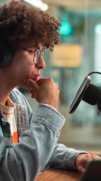 Man, microphone and laptop for podcast with discussion, on air recording and audio conversation. Radio presenter, live stream and person with interview in studio for content creation and talk show