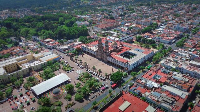 Basilica of Our Lady of Zapopan Featuring a Cinematic Aerial Drone Push In Flight Over the Entrance Avenue and Public Square under a Clear Blue Sky in Jalisco Mexico