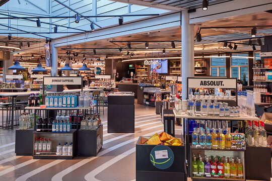 Duty free shop interior with displays of liquor, vodka, gin, and kitchen bar at Nuremberg Airport.