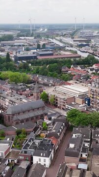 Aerial View Of Dutch City With Wind Turbines In Background