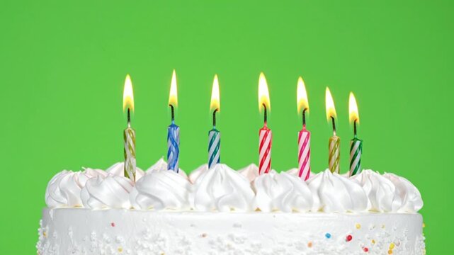 Birthday Cake with Seven Lit Colorful Candles Burning on Green Screen