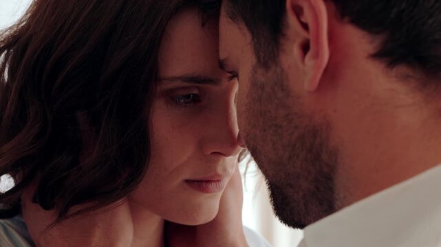 Sad, woman and couple with kiss in home for conflict resolution, rebuild connection or sorry. Reconciliation, upset person and affection in house for partner apology, marriage tension and compromise