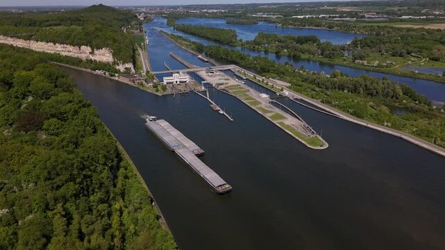 Barge navigating through Ecluse de Lanaye lock on the Maas river between Belgium and Netherlands