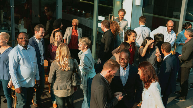 Diverse group socializing outdoors photo