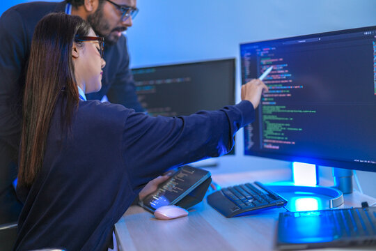 Close up portrait of a focused Chinese female developer using a stylus to validate semiconductor memory cell data and logic on a touchscreen.