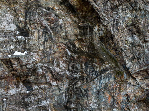 Rugged Snowy Rock Face on Mountain Peak in British Columbia Canada With Textured Orange Granite