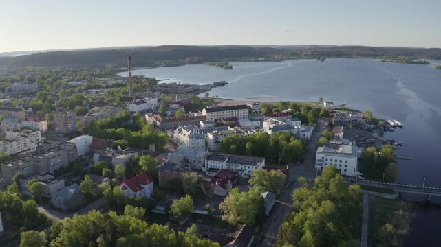Backward reveal drone footage of Sortavala town on sunny summer morning. Karelia, Russia.