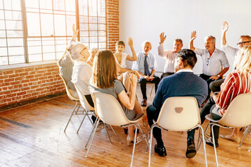 Fototapeta premium Team meeting with raised hands