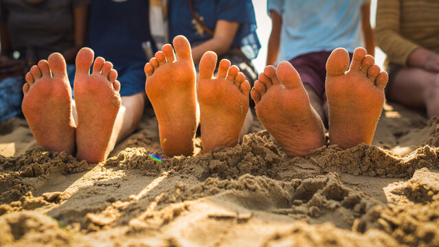 Friends relaxing sandy beach toes