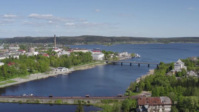 Rising up aerial shot of Sortavala town and Ladoga lake on sunny summer day. Karelia, Russia.