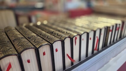 Close-up perspective of antique leather bound books with decorative gilded spines and red bookmarks for vintage bookshelf background and banner design © iri.madrid.art
