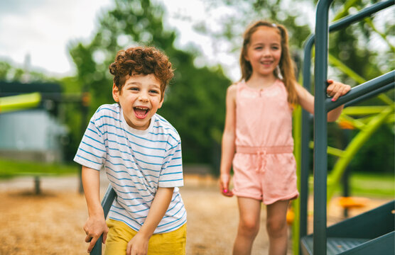 Happy kids on playground in summer season