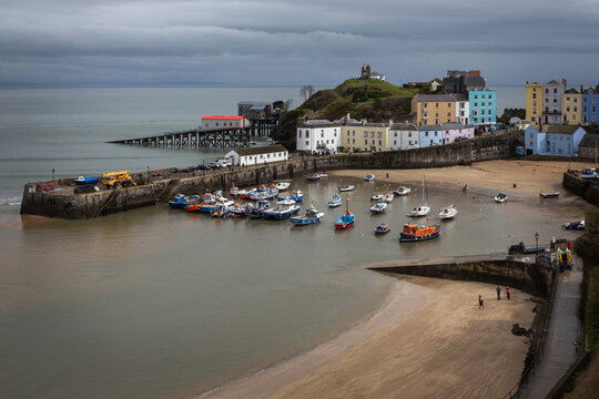 Colourful harbour houses and moored boats at Tenby Harbour Wales