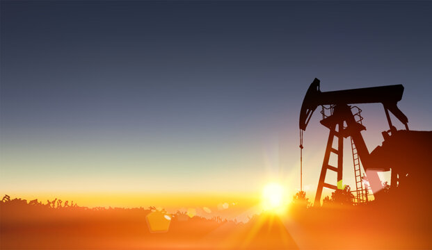 Oil derrick industrial machine for drilling at the sunset. 