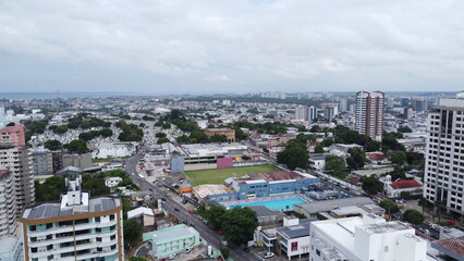 Fototapeta premium Drone Manaus-Amazonas-Brazil Aerial view of a sprawling city with a large cemetery and a swimming pool complex under a cloudy sky
