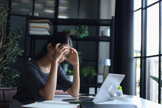 Beautiful women working in office, feeling sick and headache.