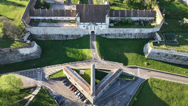 Aerial view of the historic Besancon Citadel featuring stone fortifications, tiled roofs, and green moats in Besancon, Bourgogne-Franche-Comte, France.