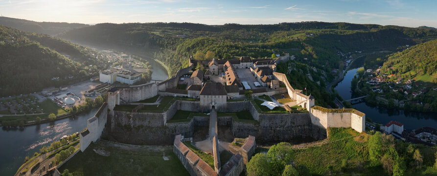 Aerial view of the Besancon Citadel overlooking the Doubs river loop and historic stone walls surrounded by lush green hills in Besancon, Bourgogne-Franche-Comte, France.
