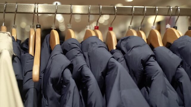 Clothes on hangers in store, close up of textile.