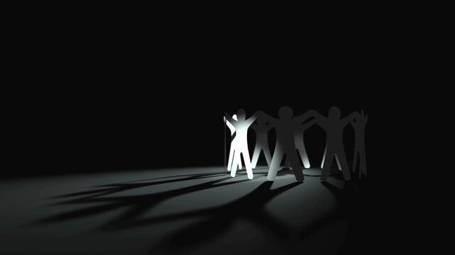 Group of abstract human paper figures standing in a circle holding hands representing teamwork and community unity