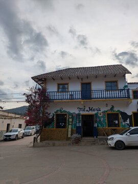 Samaipata, Bolivia - 12 October 2024: Traditional Colonial House with Colorful Mural and Wooden Balcony in Samaipata Bolivia Picturesque Street View of Historic Town Architecture Travel Destination So