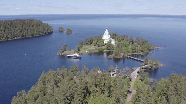 Rising up aerial shot of St. Nicholas Skete of Valaam Monastery on sunny summer day. Ladoga lake, Karelia, Russia.