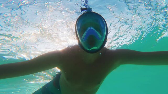 Man Snorkeling Underwater Turquoise Sea with Bright Sunlight