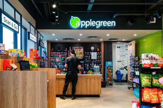 Brutus, New York - Apr 14, 2026: Applegreen convenience store at the Port Byron Service Area. The space features a staffed checkout counter, Scan & Go stations, snack displays, and cigarette shelving