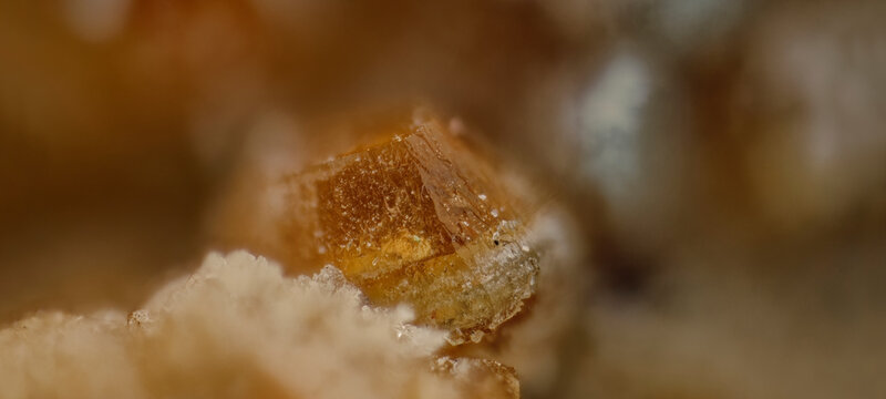 Macro photography of polychrome orange Quintinite crystal with copy space for text. Mineral specimen detailed background for designers
