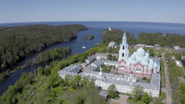 Forward reveal aerial shot of Valaam Monastery on sunny summer day. Ladoga lake, Karelia, Russia.