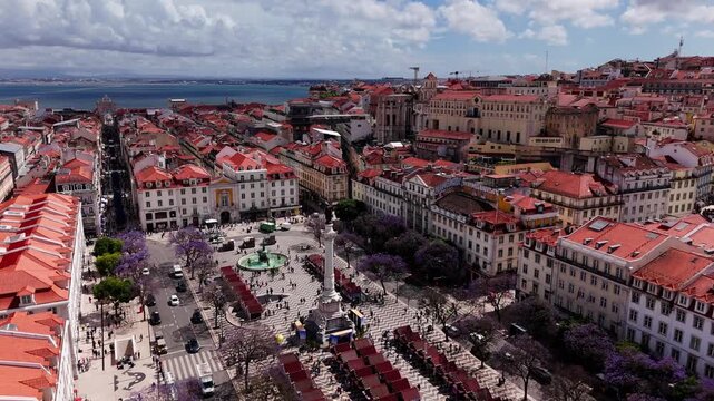 Aerial reveal of Rossio Square and Baixa district in downtown Lisbon Portugal