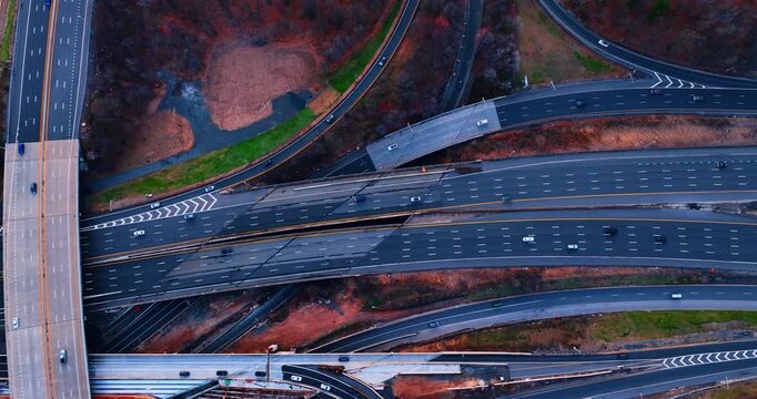 Motorways and trestle with lots of moving cars. Drone footage over the lively highways at the suburbs.