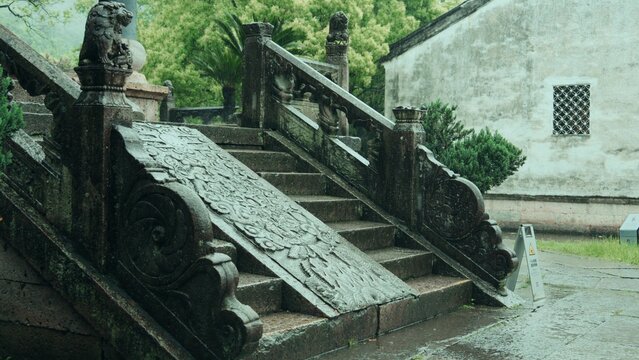 Chinese garden stone stairs with carved railings and white wall architecture