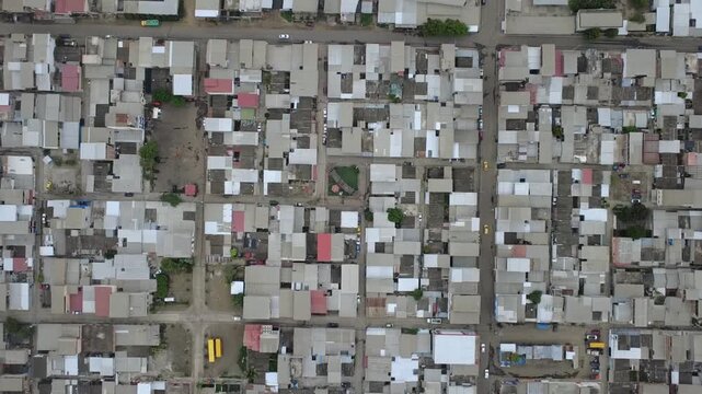 Aerial top down view of a dense south American residential neighborhood whit metal roofs at Manta,  Ecuador.