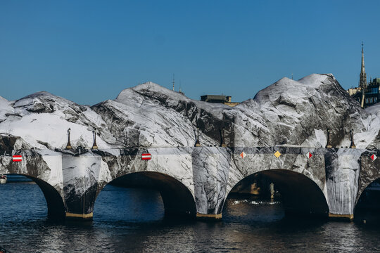 Paris, France - May 21, 2026: The historic Pont Neuf bridge transformed by French artist JR into a monumental cave-inspired temporary public art installation