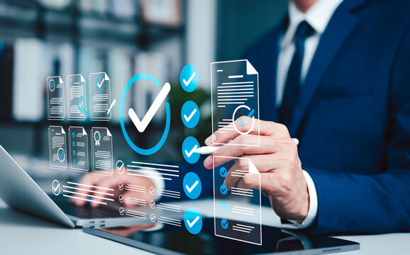 Document approval and checklist verification concept. Businessman using laptop with verified files, check marks, certificate, validated forms, workflow review, compliance process and quality control