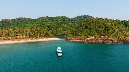 Traditional boat anchored near wai chaek beach with tropical palms and clear water © FranciscoJavier
