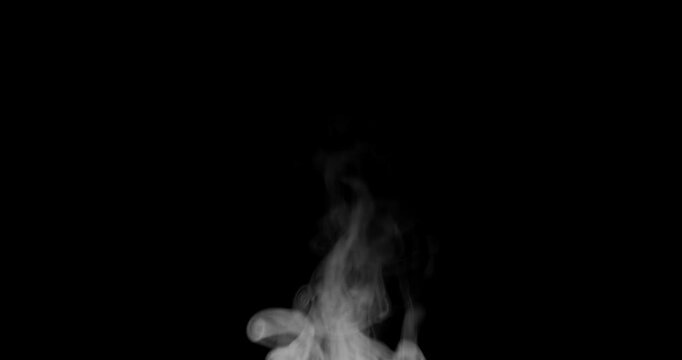 White isolated steam rises in graceful curves on a black background in slow motion. This steam trickle is perfect for overlay use with various blending modes, hot drink or food steam concepts.